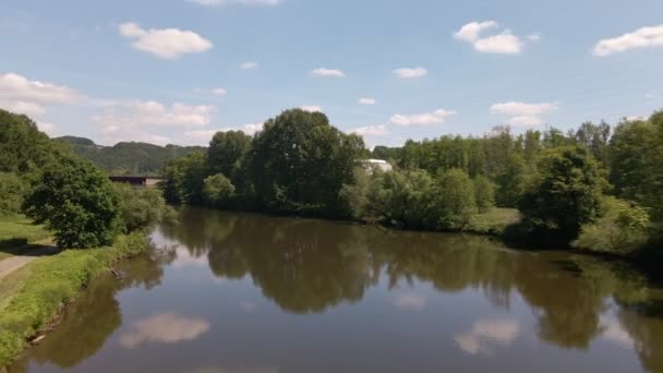 Blue Sky Lush Trees Reflecting Brown Water Calm River West — ストック動画