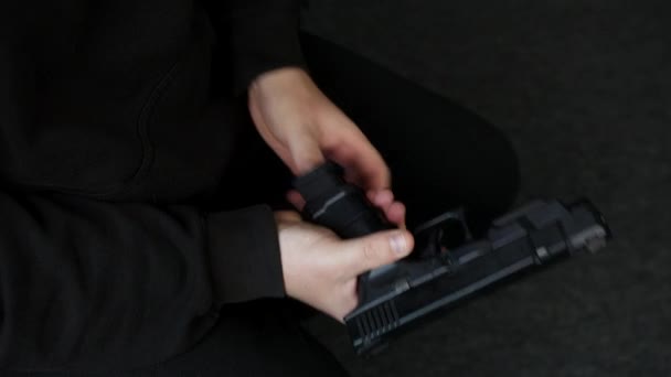 Man Loading Cocking Pistol Hand Gun While Sitting — Vídeos de Stock