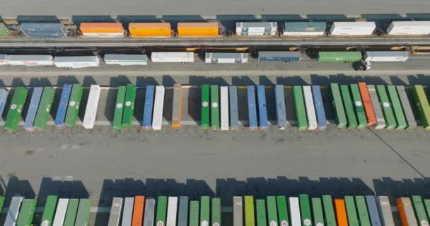 Aerial Drone Scanning Parked Shipping Containers Rail Yard Colorful Boxcars — 비디오