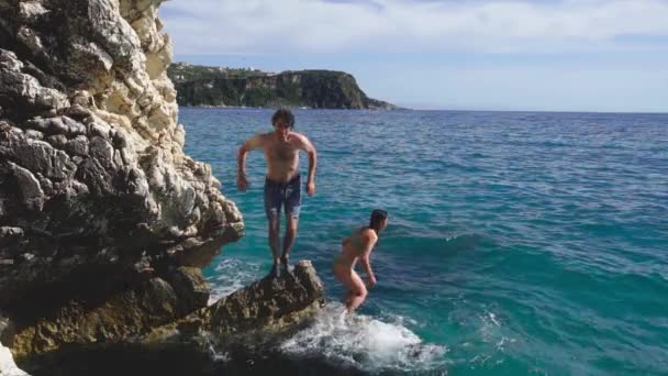 Joyful Tourists Wearing Swimwear Diving Sea Rocky Shore Slow Motion — Stockvideo