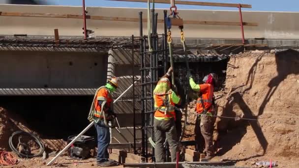 Construction Workers Releasing Crane Straps Placement Rebar Bridge Pillar — Stockvideo