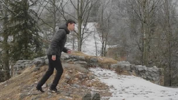 Young Man Jumping Running Wall Medival Ruin Touching Wall Cloudy — Stockvideo