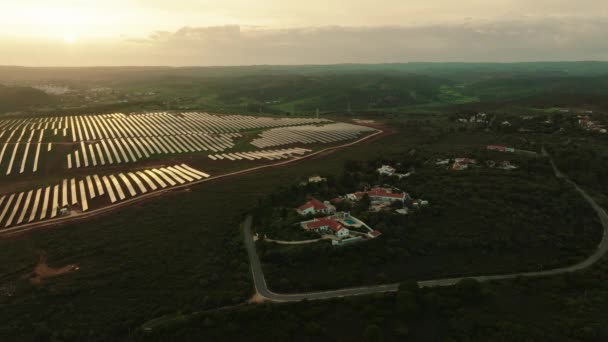 Aerial Shot Solar Panel Farm Squeezed Houses Rural Area Sunset — 비디오