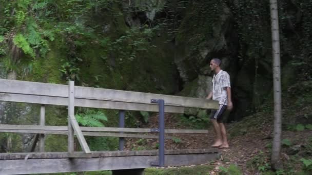 Young Man Walking Barefoot Wooden Bridge Forrest Deeper Wodds Background — Vídeos de Stock