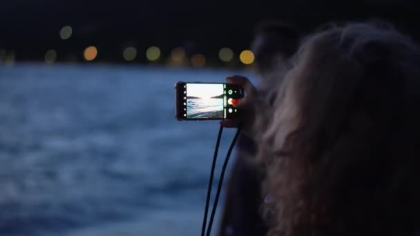 Woman Taking Photo Beautiful Sunset Seascape Smartphone Camera Blonde Hair — Vídeo de stock