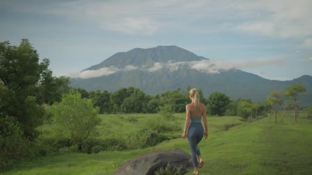 Calm Sporty Attractive Woman Standing Rock Grass Field Looking Volcano — Stockvideo
