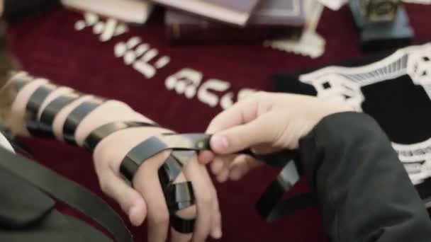 Tying Tefillin Strap Palm Chassidic Boy Bar Mitzvah Boy Puts — Stockvideo