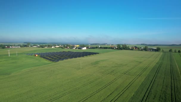 Aerial Solar Panel Units Wind Turbine Green Grass Field Blue — Stock Video