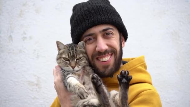 Happy Handsome Man Hoodie Jacket Bonnet Cuddles His Cute Cat — Video Stock