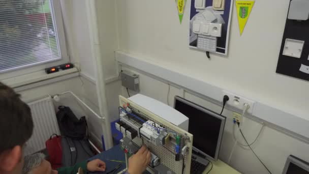 Adult Male Teacher Helping Young Student Build Electrical Switch Board — Vídeo de stock