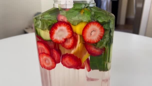 Close Glass Carafe Filled Fruit Infused Spa Water Lemon Strawberry — Video Stock