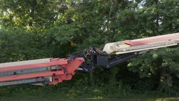 Low Angle View Construction Crane Arm Basket Green Trees Background — Video