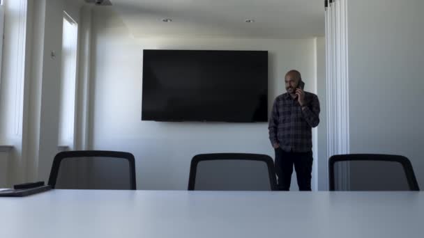 Bald Indian Male Talking Phone Walking Back Forth Modern Empty — Vídeo de Stock