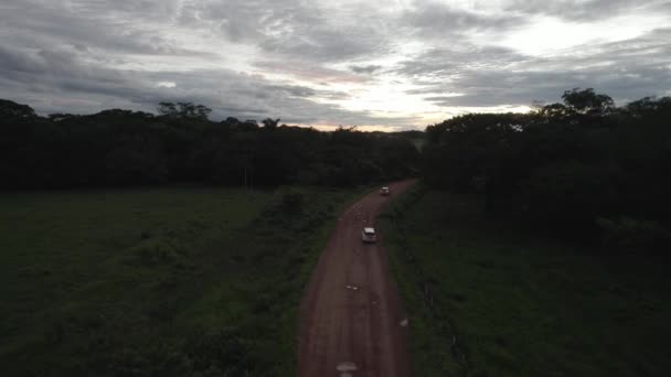 United Nations Cars Travelling Country Road Sunrise Drone Follow Shot — Stock video