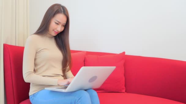 Asian Woman 30Th Typing Laptop Computer Holding Laps Sitting Red — Stock Video
