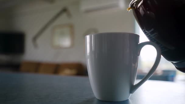 Coffee Pot Enters Frame Begins Pouring Hot Coffee White Mug — Stock Video