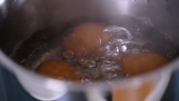 Close Brown Eggs Pot Boiling Water Stovetop Bubbles Emerge Water — Stock Video