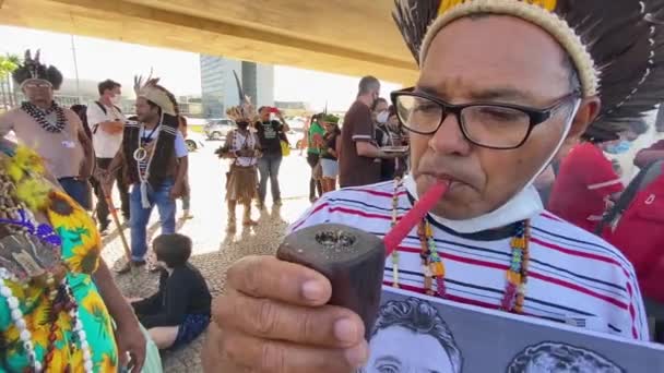 Native Brazilian Man Smoking Handcrafted Pipe Wearing Feathered Headdress Holding — Stock video