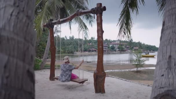 Adult Bearded Man Swinging Beach Swing Thail Island Trip Cloudy — kuvapankkivideo