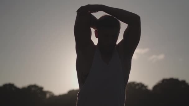 Man Stretches Works Out Whilst Being Silhouetted Evening Sun Slow — Vídeos de Stock