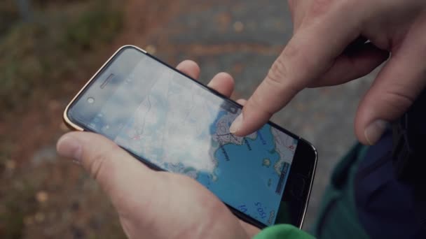 Camper Using Terrain Map Smartphone — Stockvideo