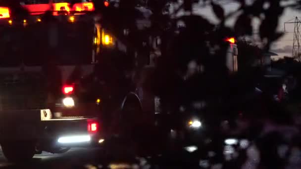 Dynamic Shot Using Foreground Leaves Background Firetruck Its Lights Storm — Video
