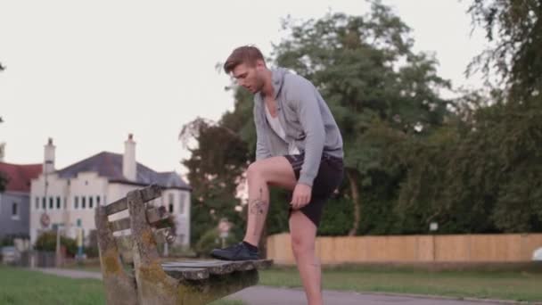 Young Athletic Man Ties His Shoes Bench Park Sets Run — Stock Video