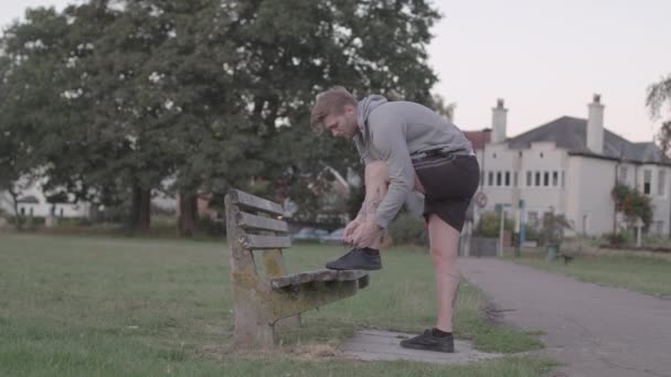 Young Attractive Man Tying His Shoes Bench Sets Run Slow — Wideo stockowe