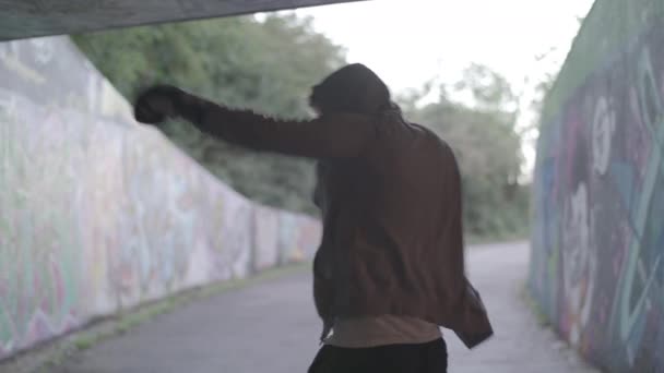 Medium Shot Young Active Man Boxing Underpass Silhouetted Light Ungraded — Vídeos de Stock