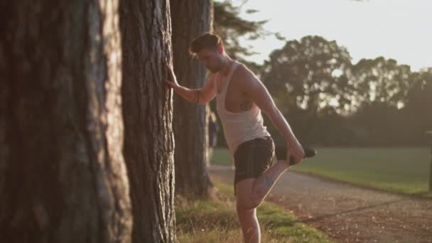 Man Park Stretching Out His Legs Goes Run Whilst Sun — Wideo stockowe