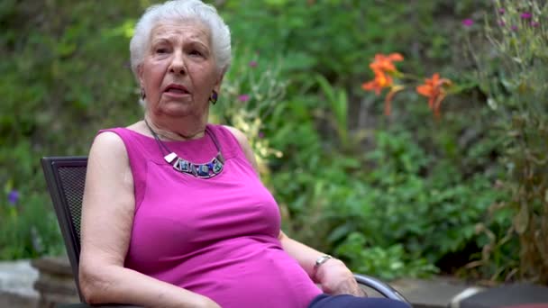 Elderly Woman Has Face Amazement Shock While Sitting Garden Area — Stockvideo