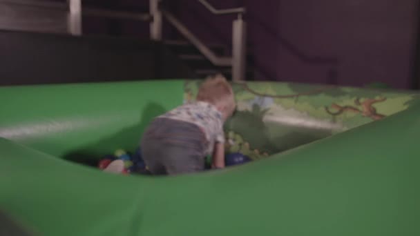 Young Boy Plays Ball Pit Throws Balls Whilst Smiling Ungraded — Αρχείο Βίντεο