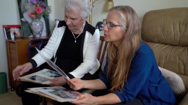 Closeup Mature Blonde Woman Looking Photo Album Laughing Talking Elderly — Vídeos de Stock