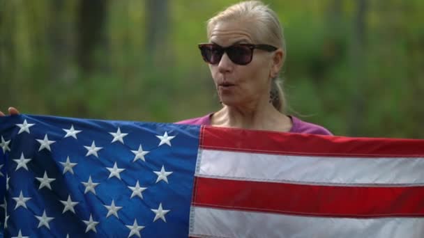 Closeup Pretty Blonde Woman Holding American Flag Showing Surprise Excitement — Stockvideo