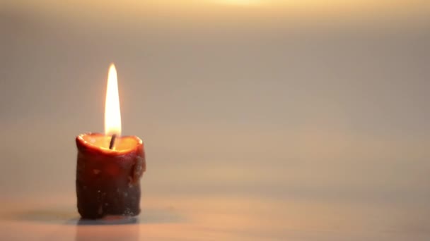 Single Candle Flickers Reflections — Stockvideo