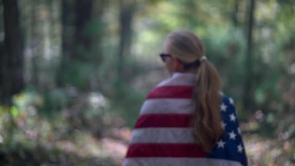 Slow Motion Out Focus Woman Wrapped American Flag Walks Path — Stock Video