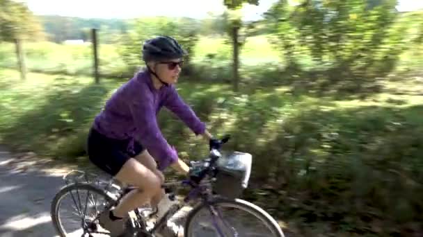 Camera Pans Woman Mountain Bike She Passes Camera Reveals Her — Vídeos de Stock