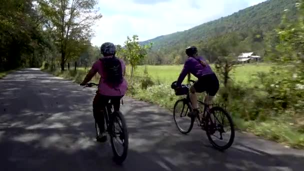 Camera Mother Teenage Son Biking Side Side Rural Road Farm — Stock video