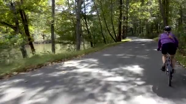 Woman Biking Shady Road River — 图库视频影像