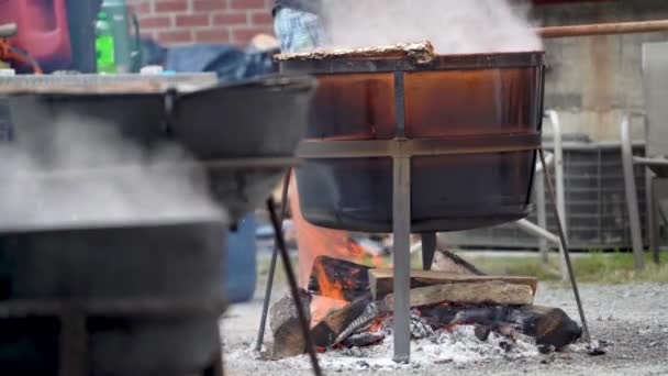 Very Tight Shot Several Steaming Cauldrons Smoking Wood Fires — Vídeos de Stock