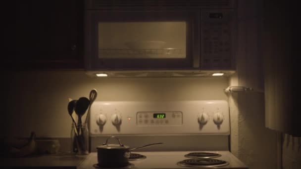 Apartment Kitchen Scene Microwave Running Night — Stock Video
