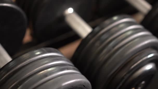 Extreme Closeup Slow Slider Shot Right Looking Row Dumbbells Rack — 비디오