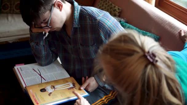 High Angle Shot Homeschool Son Mother Reviewing History Assignment Textbook — Vídeo de stock