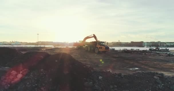 Tracking Aerial Shot Excavator Digging Loading Dirt Truck Sunset Pulls — Video