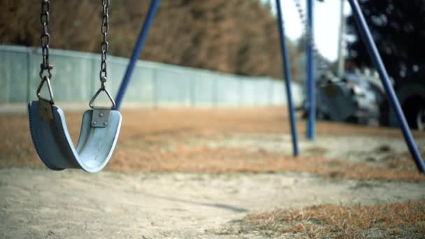 Abandoned Empty Swing Set Swings Swaying Wind Children Playground Fenceline — Vídeo de Stock