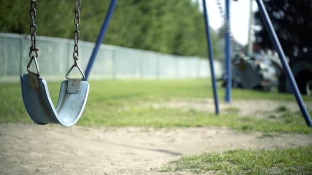 Abandoned Empty Swing Set Swings Swaying Wind Children Playground Fenceline — ストック動画