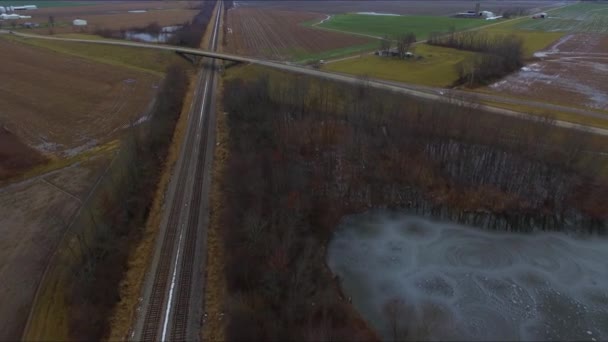 Cars Trucks Bus Traveling Overpass Running Railroad Tracks Next Pond — Stockvideo