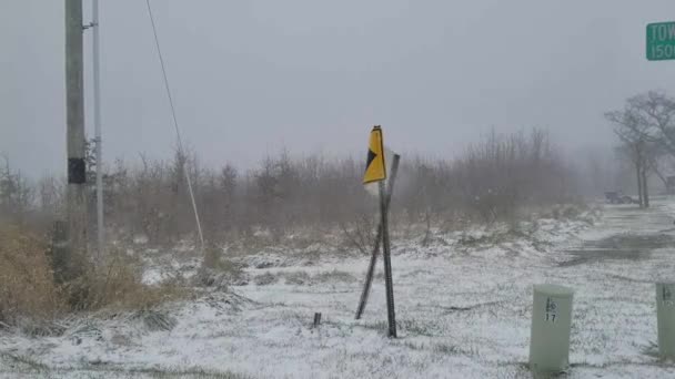 Road Sign Broken Leg Whips Violently Wind Heavy Snow Storm — стоковое видео