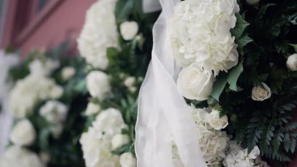 Wedding Wreath Flowers Dangling Ribbon Blows Wind Old Church Door — 图库视频影像