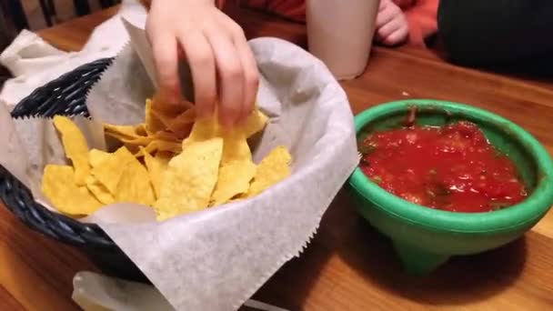 Family Shares Basket Chips Bowl Salsa Dinner Mexican Restaurant — Vídeo de Stock